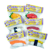 6 differently designed 3D sushi erasers in packaging bags with yellow header cards with purple Japanese writing. Sushi designs include roe, salmon, tuna, squid, tamago, and uni.