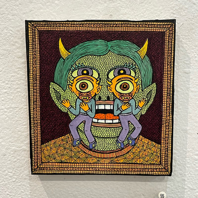Illustration on wood of a green, horned goblin with scaled skin wearing a patterned sweater. 2 twin cyclopses with horns stand in front of the goblin's face.