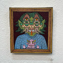 Illustration on wood of a green long haired goblin, wearing a swirl patterned sweater with a small pink monster in front of its chest. Two matching cyclopses block the goblin's face.