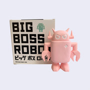 Sculpted light pink colored Big Boss Robot, standing with its arms at its side. Behind is a product packaging box that reads "Big Boss Robot" in bold all caps font, with Japanese script below. An illustrated Big Boss Robot is in upper right corner.