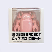 Sculpted light pink colored Big Boss Robot, encased in a display packaging box, with the top 3/4ths of the robot viewable and the rest blocked by packaging that reads "Big Boss Robot" in bold black font with Japanese script underneath.