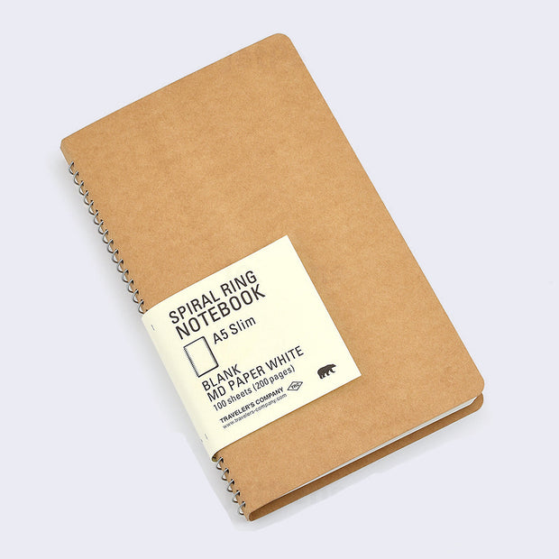 Kraft paper blank cover notebook with rounded corners and metal spiral binding on side. Small paper insert wraps around notebook and with all the specs written, which can be read in product description.
