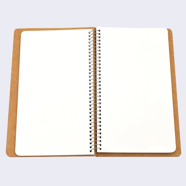Open spread of spiral ring notebook, revealing white blank pages.