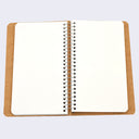 Open spread of spiral ring notebook, revealing white blank pages.