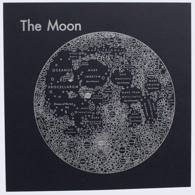 Silver silkscreen on black paper of the moon, depicted abstractly as various circles, representing craters and geographical elements, written across the planet, aligned in relation to their real location. "The Moon" is written largely in the top left.