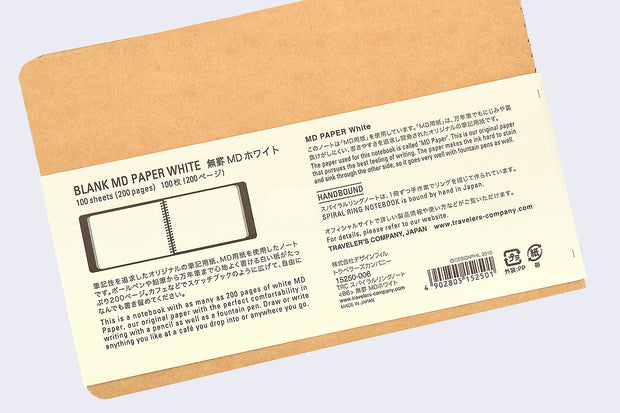 Back cover of kraft color notebook with rounded corners and metal spiral binding on side, with paper insert showing various specs written in English and Japanese.