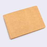 Kraft paper blank cover notebook with rounded corners and metal spiral binding on side.