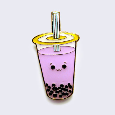 Enamel pin of a purple taro boba cup with a small smiling face.