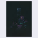 Two figures sitting in the dark, in front of a small TV with a Godzilla like creature on the screen.