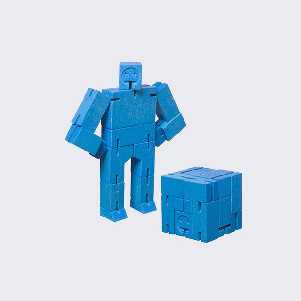 Wooden robot made out of many rectangular parts standing with its arms on its hips. The same robot is folded into a perfect cube shape in front.