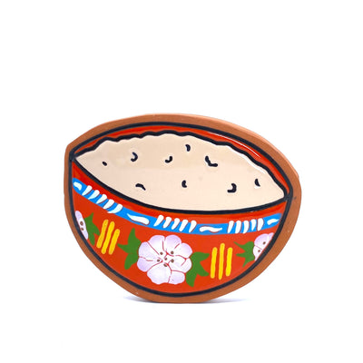 Earthenware die cut tile of a red bowl with light brown ground cacao in it. The bowl is decorated with pink flowers with green leaves, yellow lines and a blue line circling the top of the bowl with white inner line details. 