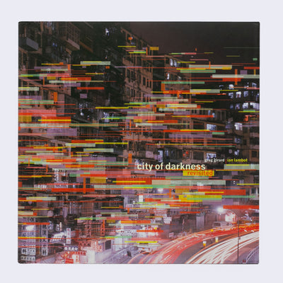 Book cover with a photograph of a night scene urban city, with blurred lights from driving cars. Buildings are stacked high and very lived in. Various thin rectangles cover the photo, as a pattern.