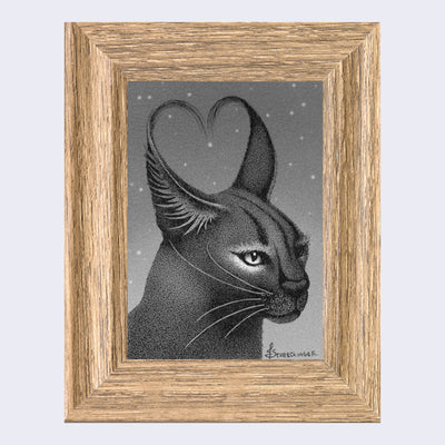 Finely rendered greyscale pen and ink drawing of a caracal, a wild cat with tall wispy ears.  It looks slightly off to the right and its two ears come together barely to form a heart. Piece is in a lighter colored thick wooden frame.