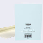 The back of note card is shown with an envelope behind it. The back of notecard is blue with text that describes where and how it was printed.