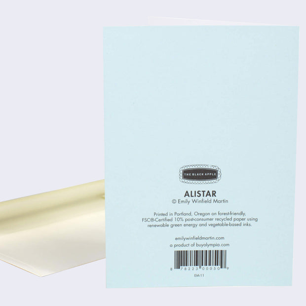 The back of note card is shown with an envelope behind it. The back of notecard is blue with text that describes where and how it was printed.