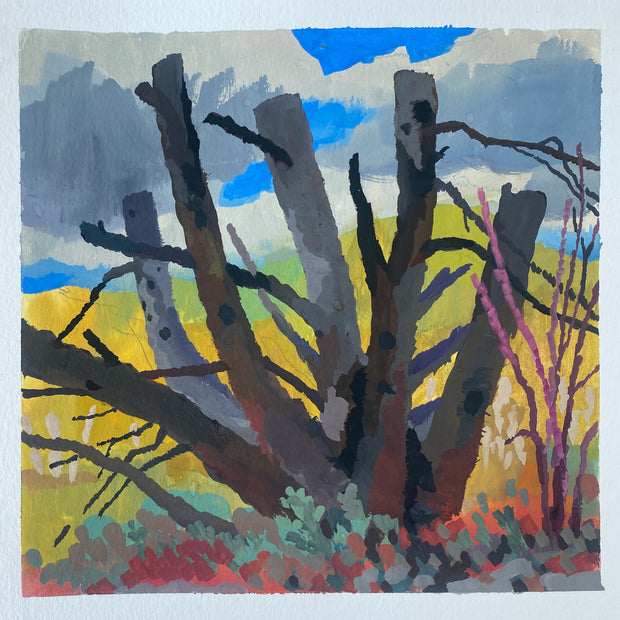 Plein air painting of a barren tree, with thick branches mostly chopped down. Yellow hills are bright in the background and red and green plants stand in front of the tree.