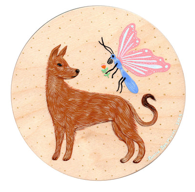 Round wooden panel with a painted dog, standing and looking over its shoulder at a large pink butterfly which holds out a flower for the dog.