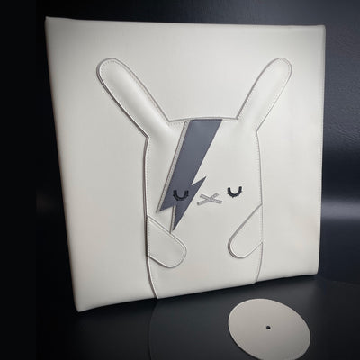 Vinyl (pleather) recreation of David Bowie's "Aladdin Sane" vinyl record cover, with a white bunny in the center instead of David Bowie, in greyscale. The bunny has closed eyes and lightning bolts over its left eye. A pleather record peeps out from the album cover.