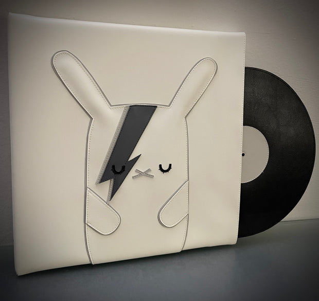 Vinyl (pleather) recreation of David Bowie's "Aladdin Sane" vinyl record cover, with a white bunny in the center instead of David Bowie, in greyscale. The bunny has closed eyes and lightning bolts over its left eye. A pleather record peeps out from the album cover.