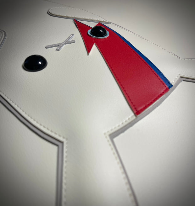 Close up photo of sewn details on plush album cover recreation, showing a white bunny with red and blue lightning bolts over the left eye.
