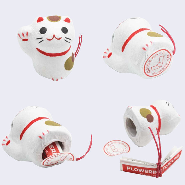 Collection of images, various angles of a white maneki Flowering Fortune, shown face up, then on its side revealing a sticker with Japanese script, then with the sticker removed, revealing a folded sheet of instructions tied with a red string.
