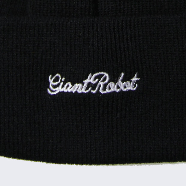 Close up of small cursive text stitched onto brim that says giant robot.