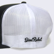 Side view of black baseball cap. Embroidered text on left side of hat says giant robot. The entire back side of hat is white mesh.