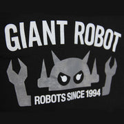 Close up of graphic on black jacket. "Giant Robot" is written in capital white font across the center, above a graphic of a gray robot head. It has 2 arms that come out of centered text that reads "robots since 1994".