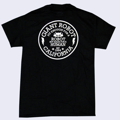 Back of an all black t-shirt, with a white circle in the upper middle. Within the circle reads "Giant Robot Fit Enough for a Robot but Made for a Human EST 1994 California" in all caps white text. Two white lightning bolts frame the text within the circle with a small Big Boss Robot head in the middle.