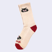 Cream colored sock with a cartoon robot head. The angry robot decorates the cuff end of each sock so that it peeks out when you wear sneakers.
