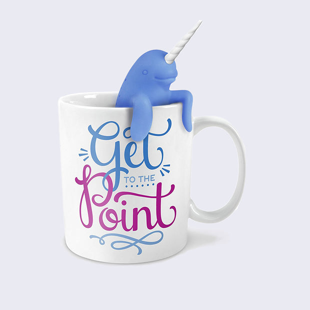 White ceramic mug that reads "Get to the Point" in stylized cursive, all blue with "point" in purple. A rubber narwhal hangs halfway into the mug.