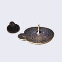 Back of enamel pin with a rubber pin backing.