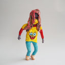 Clay sculpture of a person wearing a Spongebob shirt, tight jeans and with a long brown and pink wig on.