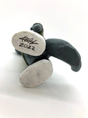 Bottom of painted sculpture, displaying the artists signature on the bottom of the foot and the year, 2022.