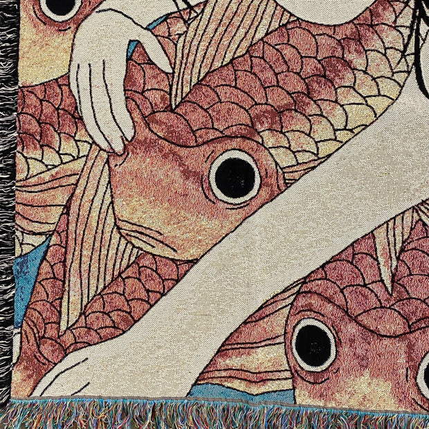 Close up detail photo of tapestry of a pink cheeked woman with long black hair, swimming amongst a densely packed group of orange koi fish.