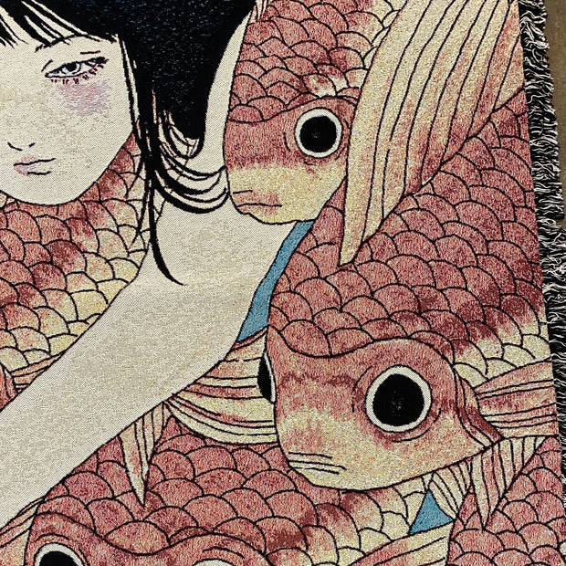 Close up detail photo of tapestry of a pink cheeked woman with long black hair, swimming amongst a densely packed group of orange koi fish.