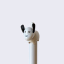 Close up of dog tail pen, light gray dog with closed eyes and black upturned ears and tails, handle of pen is light gray.