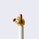 Close up of dog tail pen, light brown dog with happy closed eyes and warm brown ears and tails, handle of pen is white.