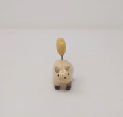 Small ceramic sculpture of a painted Siamese coloring cat, with simplistic body shapes and a drawn on face. Attached with a wire coming out of its back is a ceramic yellow crescent moon.