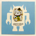 Enamel pin of a happy maneki cat, with yellow and black spots on a blue backing card.