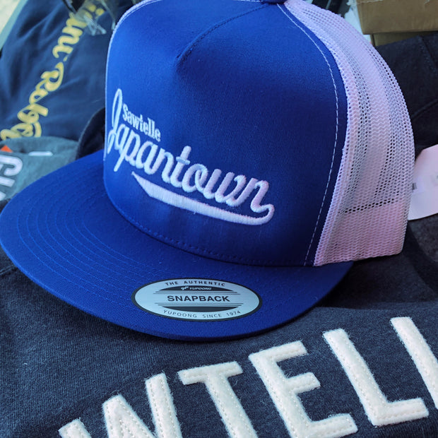 Blue hat with white mesh back and white embroidered letters that read "Sawtelle Japantown" in a neat yet stylistic font.
