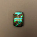 Enamel pin of glass kimchi jar glowing in the dark.