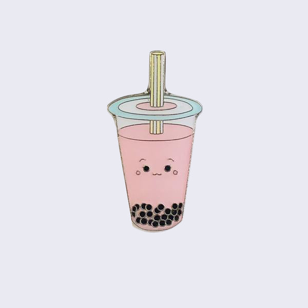Enamel pin of a pink, strawberry boba cup with a small smiling face.