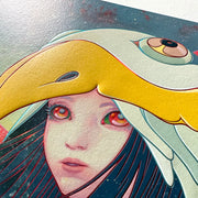 Detail of James Jean "Raven" print, a young girls face with multicolor eyes looking up. A large beaked bird sits over her head like a hood, with straight blackish blue hair framing her face.