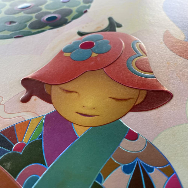 Detail photo of a colorful illustration of a semi anthropomorphic character with a flower hat and patterned kimono sitting, reading a book. Photo shows dimensionality and sheen of print.