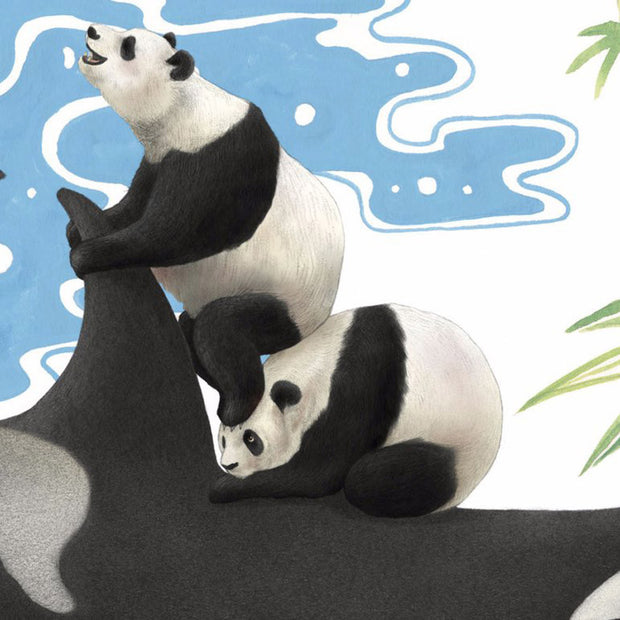 Close up of two pandas on top of an orca whale.