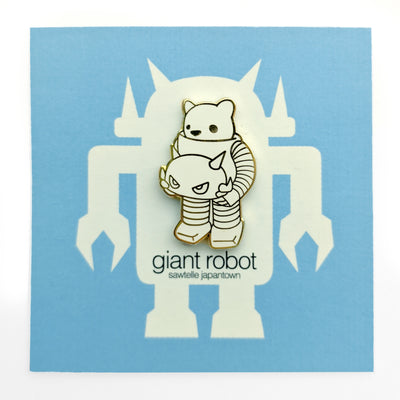 Enamel pin of a white bear inside a robot suit, holding the robot's head in its hands. Only visible part of the bear is its head. Pin is white with gold outlines.