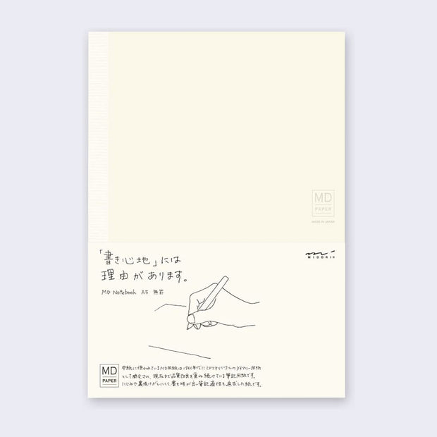 Cream colored notebook cover with a paper sleeve wrapped around with details about the notebook in English and Japanese.