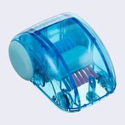 Blue plastic semi transparent dome shaped car, with small wheels and a brush mechanism inside, which turns with the wheels and rotates the bristles like a sweeper.