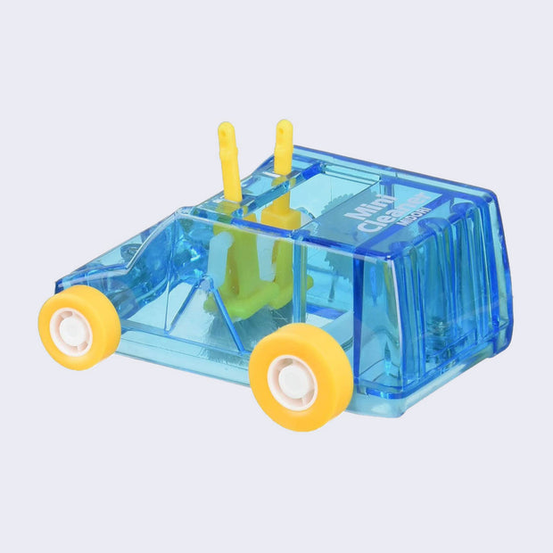 Blue plastic semi transparent box shaped car, with small wheels and 2 small brush mechanisms inside, which turns with the wheels and rotates the bristles like a sweeper.